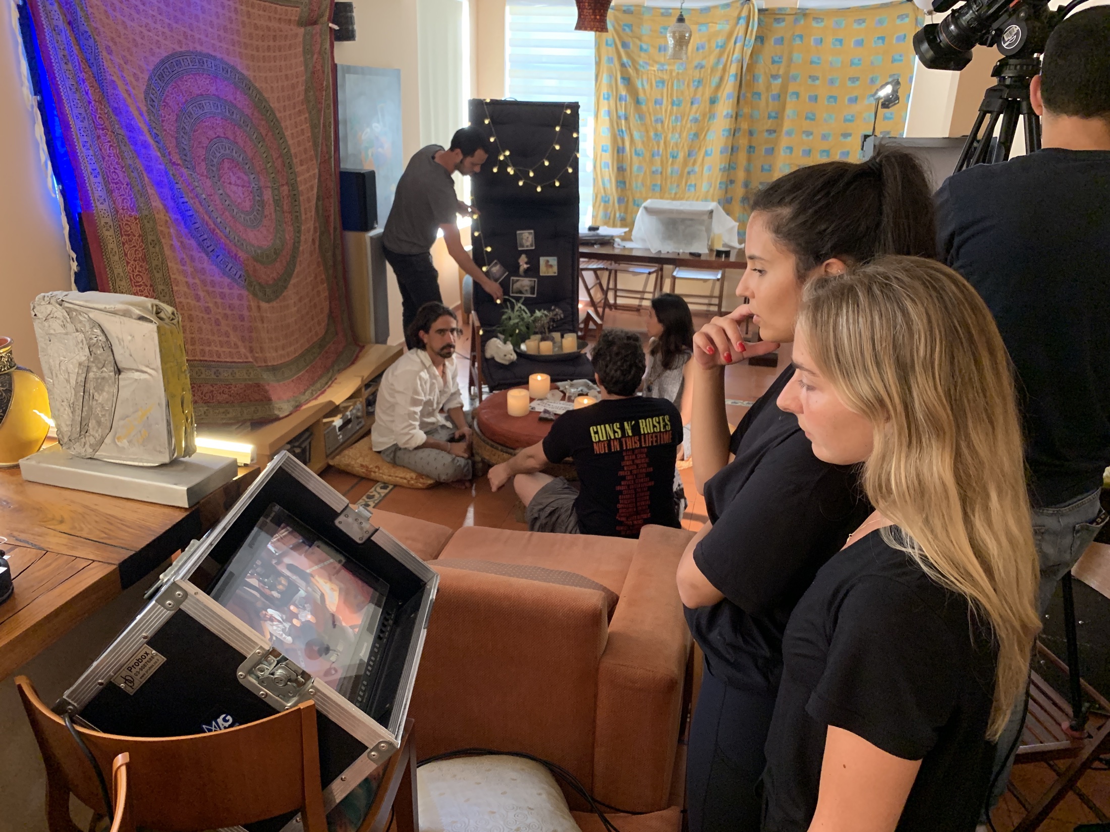 Axelle Azoulay directing beside a production monitor
